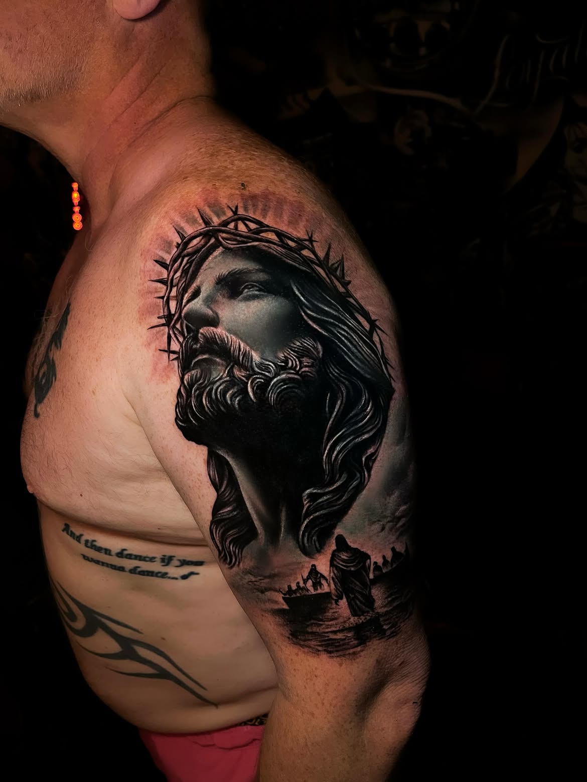 Black and grey realism tattoo of Christ on the shoulder