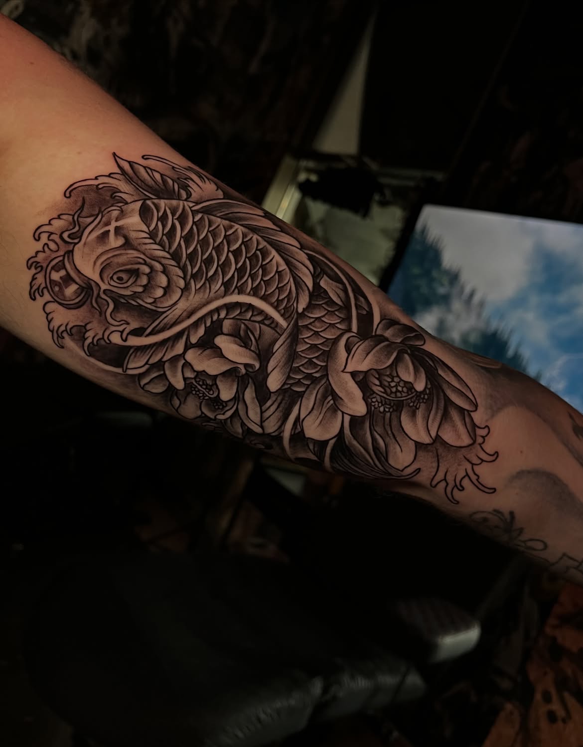 Black and grey Japanese koi and peony sleeve tattoo