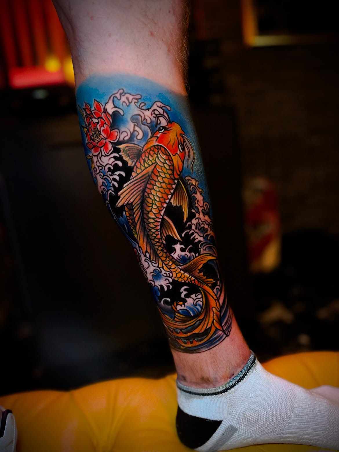 Colour neo-Japanese koi fish and lotus tattoo on the leg